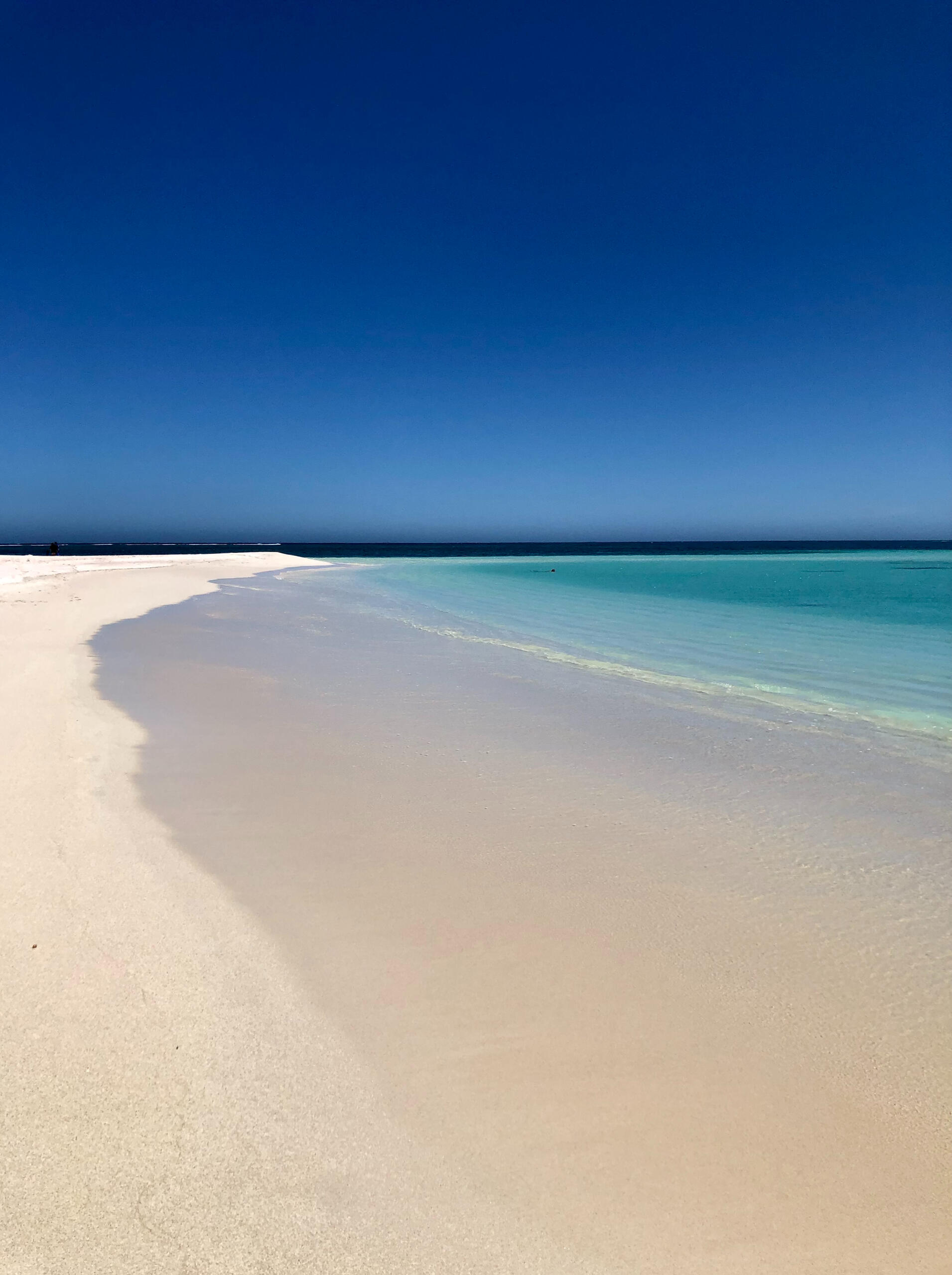 Image of white sand and tropical water.